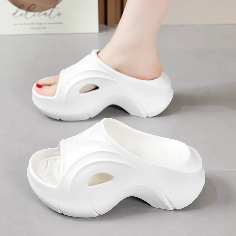 Women's white EVA beach slippers with a thick sole and round toe.