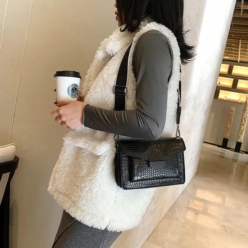Vintage-style women's crossbody bag in PU leather, shown in black, with adjustable strap.