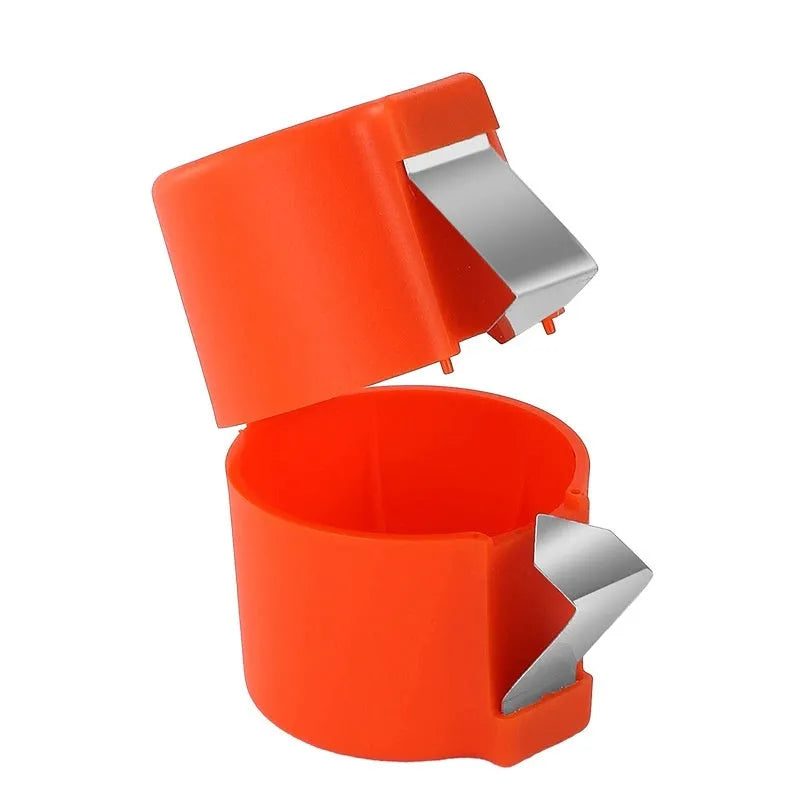 Stainless steel egg shell opener in orange red with PP plastic handle on a kitchen counter