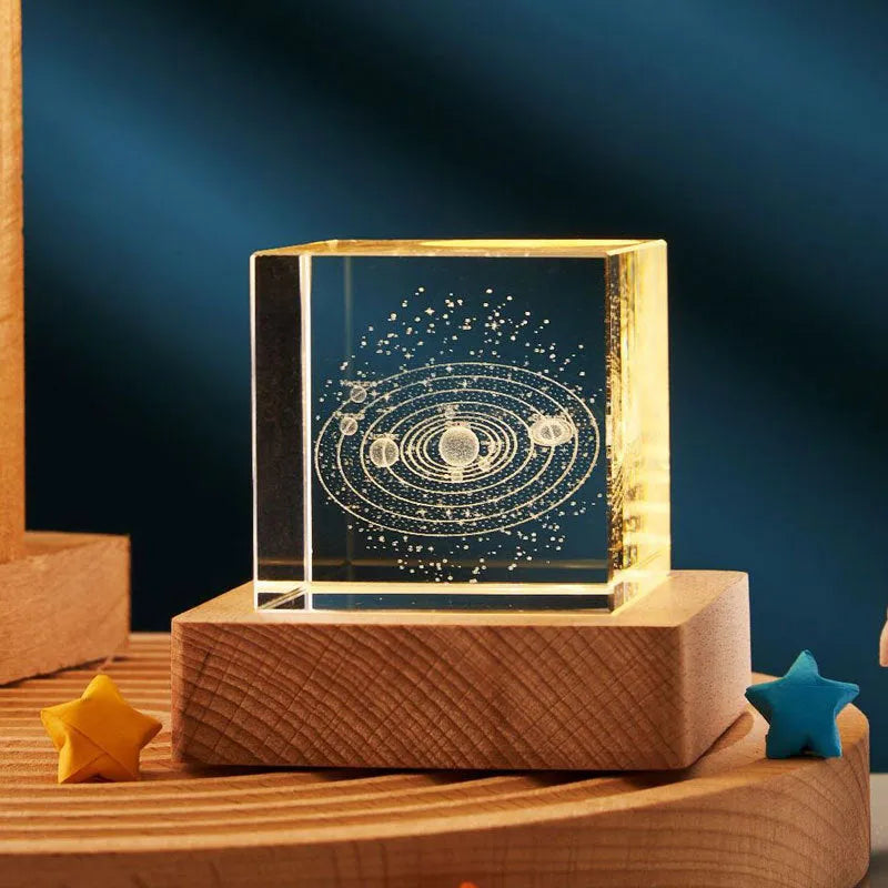 3D transparent crystal cube night lamp with warm light pattern on wooden desktop