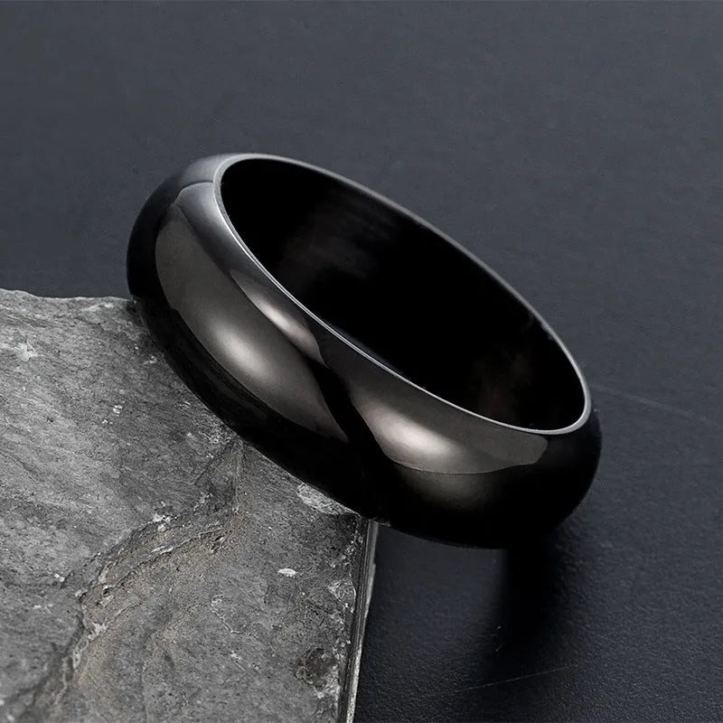 Glossy electroplated titanium steel ring in gold colour on a white background.