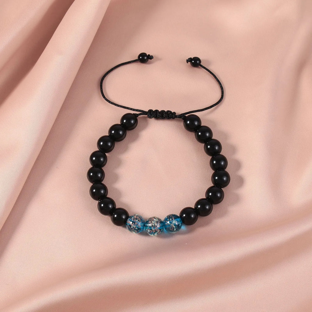 Beaded adjustable luminous bracelet in six colours: black, red, green, pink, blue, sapphire blue, glass or coloured glaze beads, geometric shape