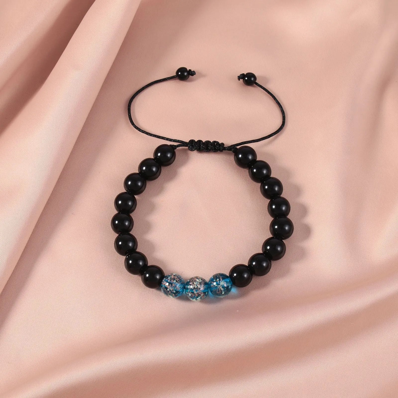 Beaded adjustable luminous bracelet in six colours: black, red, green, pink, blue, sapphire blue, glass or coloured glaze beads, geometric shape