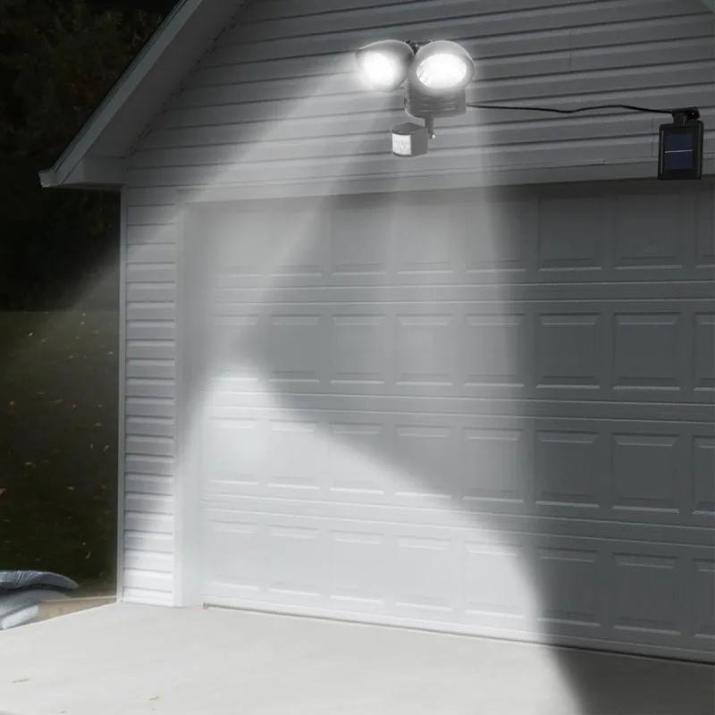 Double head solar induction spotlight in black mounted on a wall showing two LED panels