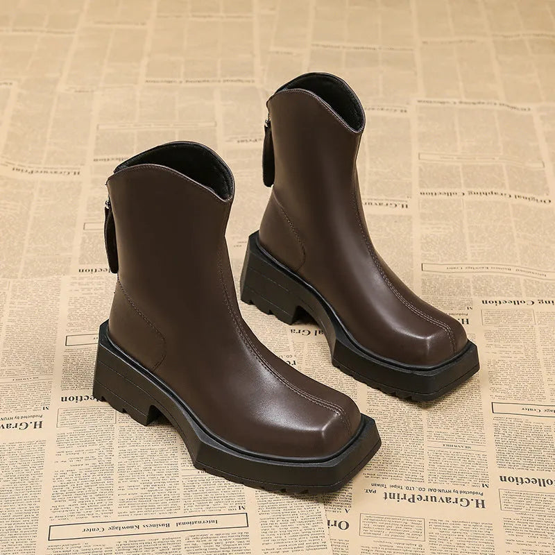 Black women's platform ankle boots with square toe, chunky sole, and rear zip fastening.