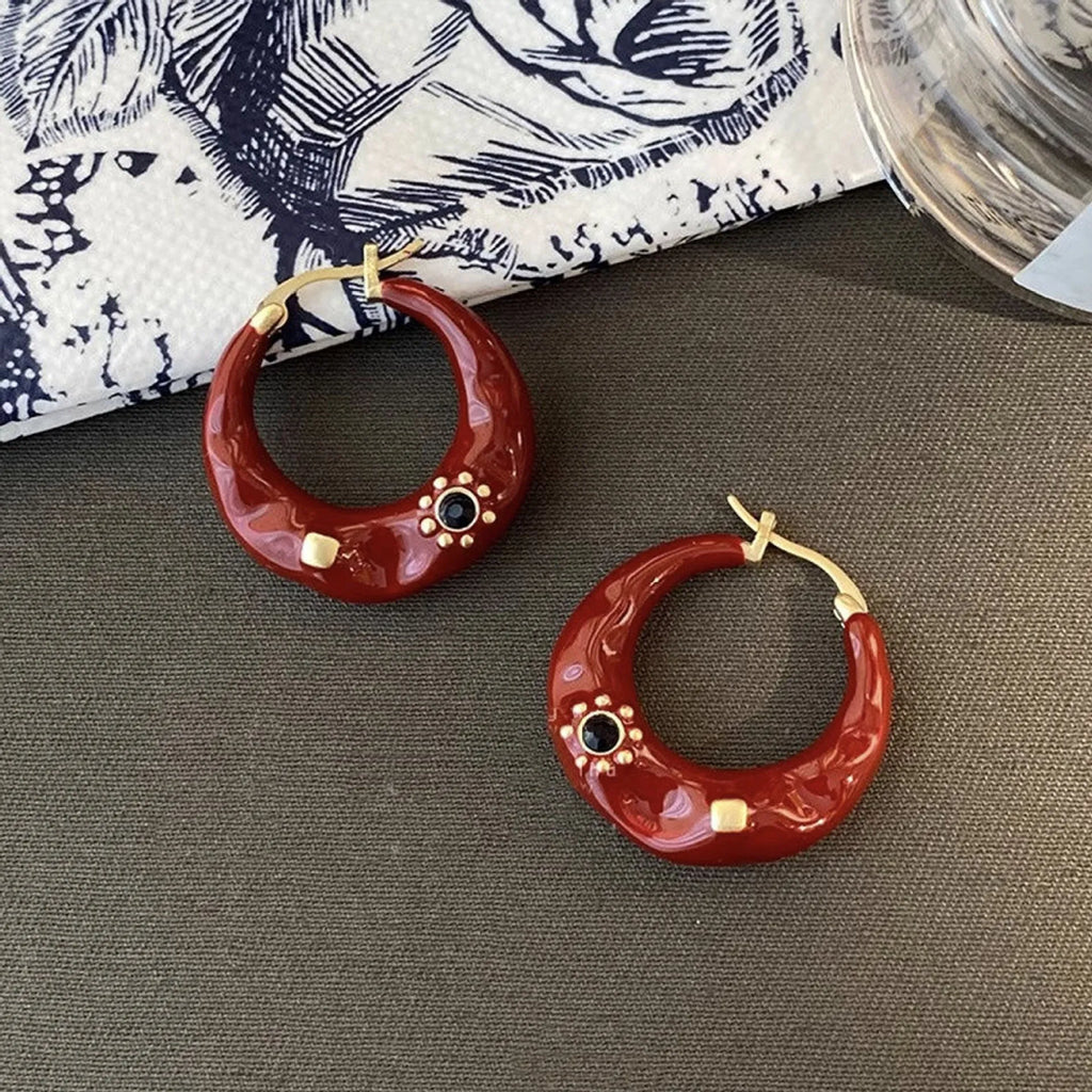 Retro style ear studs with dripping oil finish and rhinestone detailing in black and red colours