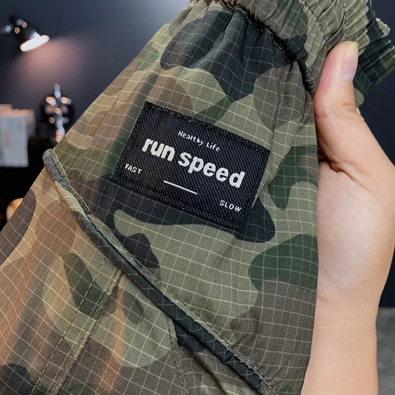 Men's camouflage pattern cargo shorts with pockets, shown in a loose fit.