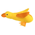 Yellow plush teddy dog toy with a attached duck doll and visible treat pockets on a white background.