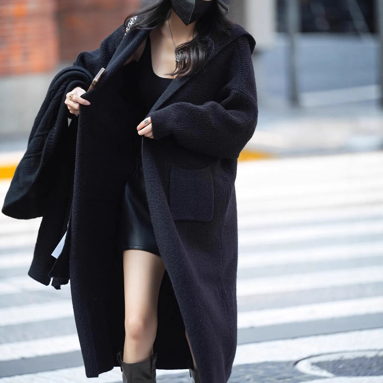 Long grey knitted cardigan trench coat with hood shown on hanger