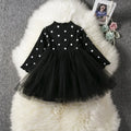 Baby girl wearing long sleeve lace tutu dress in pink for birthday party