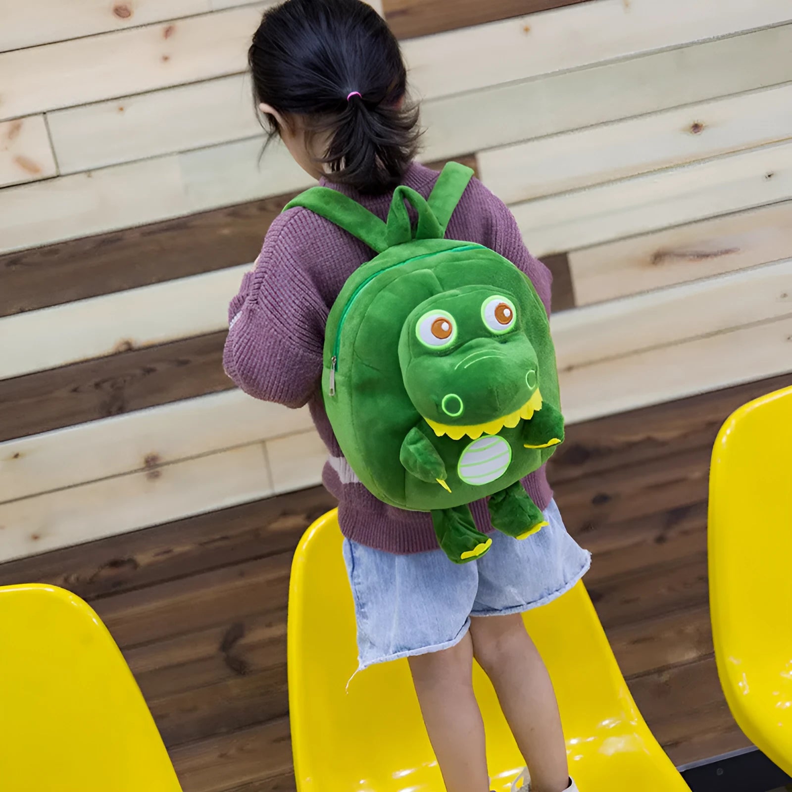 Blue dinosaur plush backpack with embroidery detailing and soft handle for children