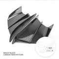 Universal motorcycle spoiler wind wings in pure black finish with glossy forged pattern, side view on a dark background.