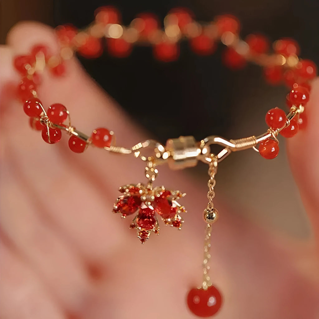 Red ginkgo leaf magnetic bracelet in alloy with electroplated finish on white background