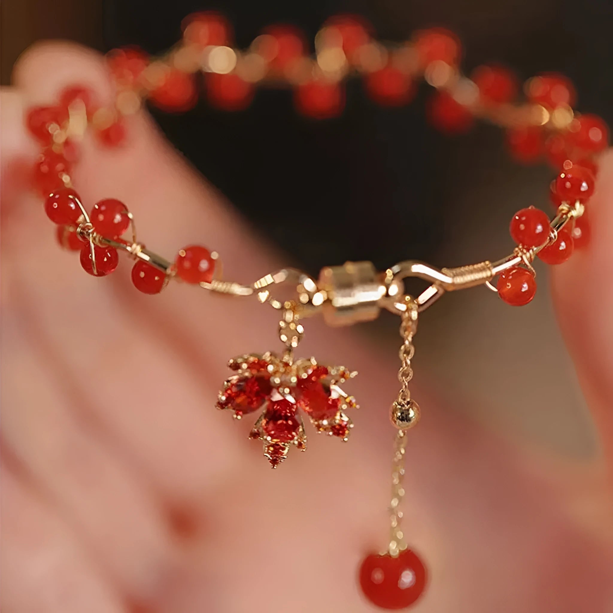 Red ginkgo leaf magnetic bracelet in alloy with electroplated finish on white background