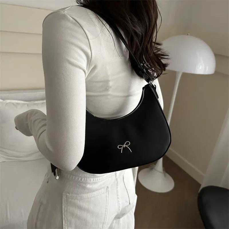 Women's underarm small bag in black PU with single shoulder strap and stitching detail