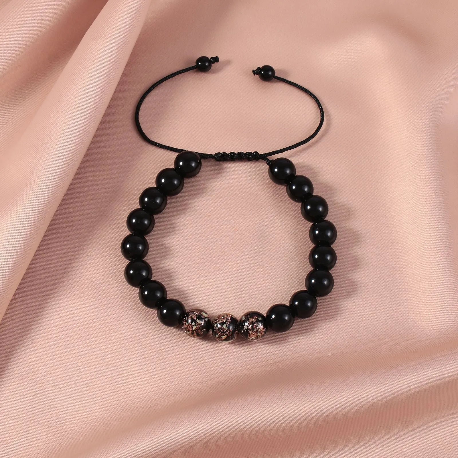 Beaded adjustable luminous bracelet in six colours: black, red, green, pink, blue, sapphire blue, glass or coloured glaze beads, geometric shape