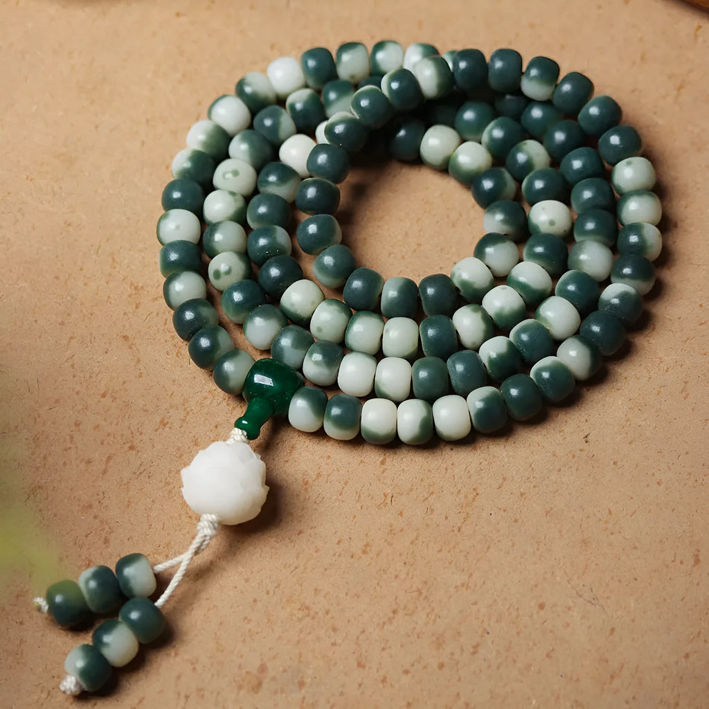 Lotus White Jade Bodhi Beads Bracelet with 8x10mm floating flowers beads on a neutral background