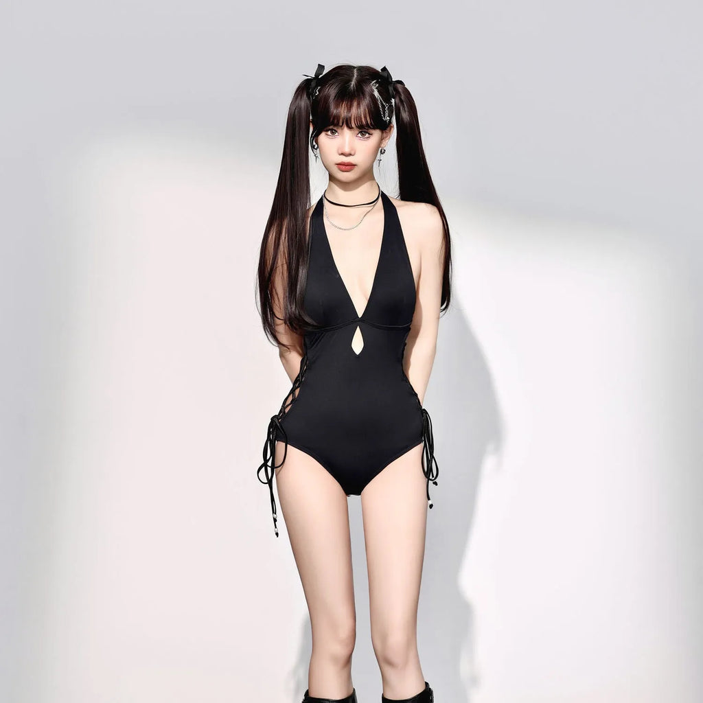 Women's black V-neck hollow strap niche one-piece swimsuit on plain background