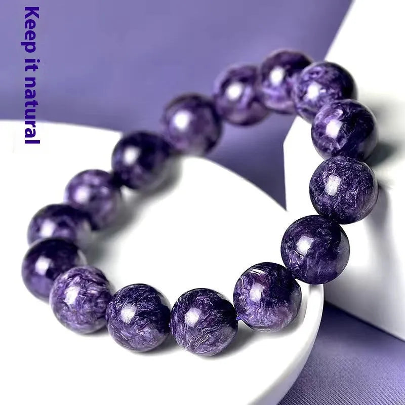 Natural transparent charoite crystal bracelet with platinum links, showing different bead size options.