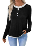 Women's black fake two-piece pullover sweater with button front and round neck on a hanger.