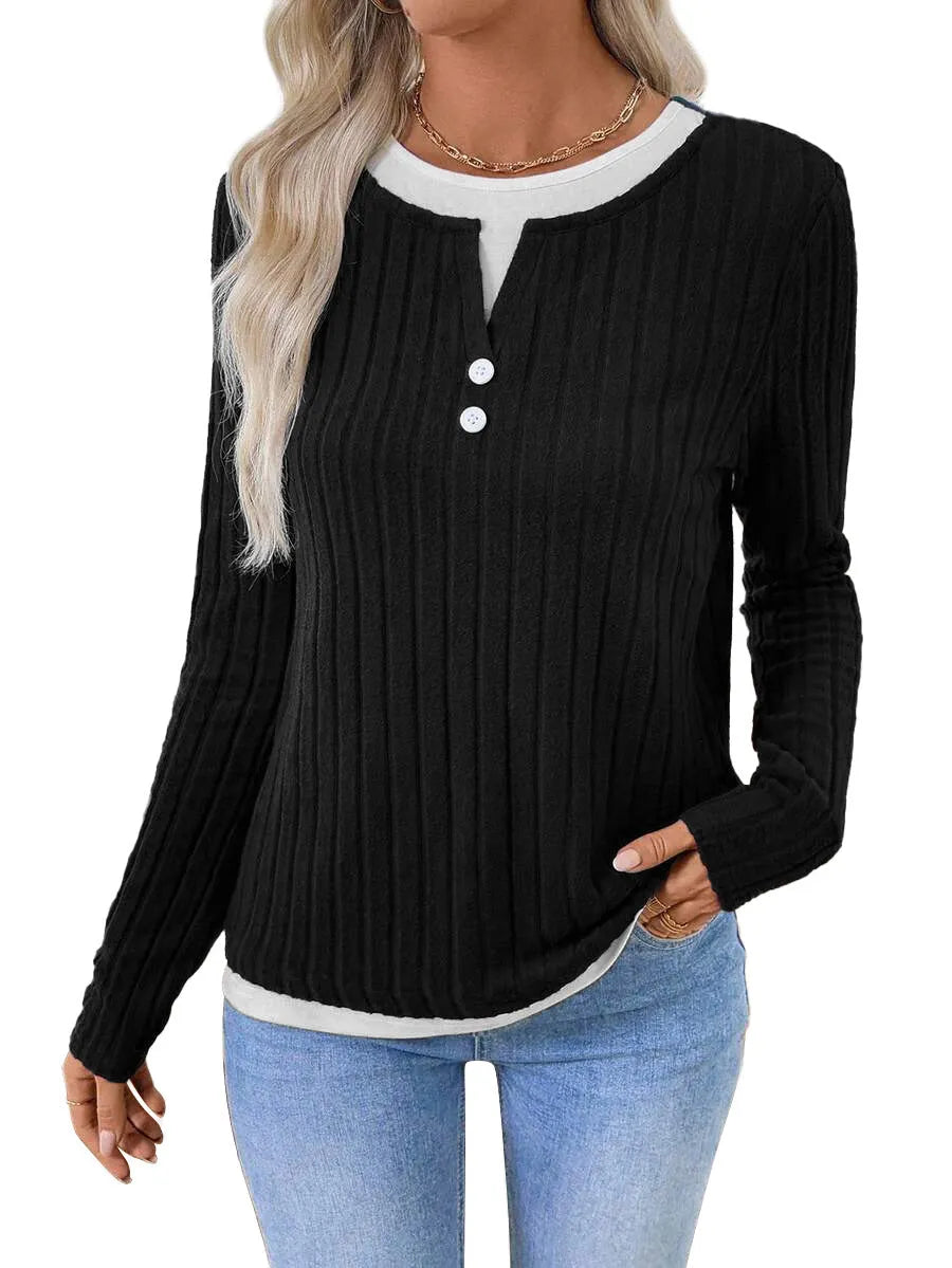 Women's black fake two-piece pullover sweater with button front and round neck on a hanger.