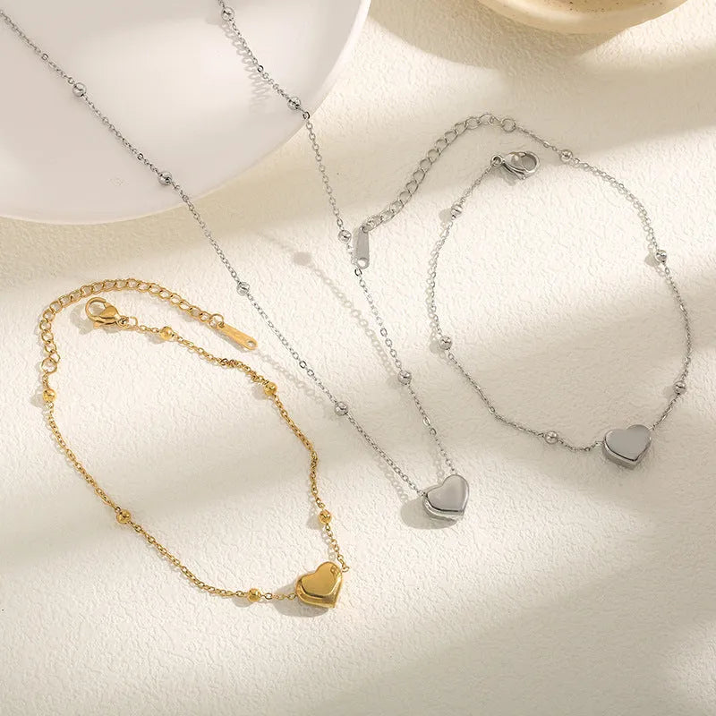Women's titanium steel necklace with geometric pendant and ball bead chain in silver finish on white background