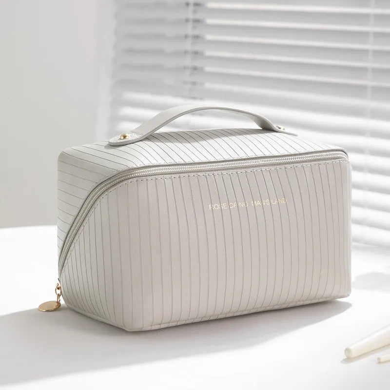 Vertical pattern makeup bag with cubic 22.5cm dimensions in beige, black, brown, grey, and pink colour options