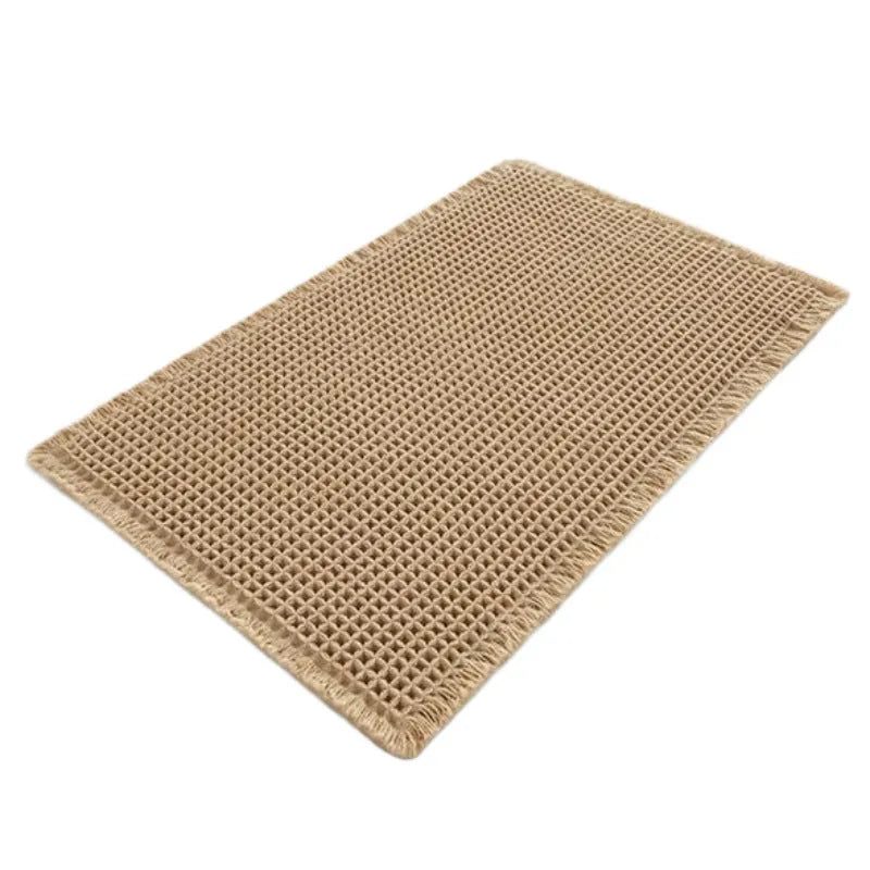 Checkered pattern non-slip polyester bathroom mat in beige colour on tiled floor.