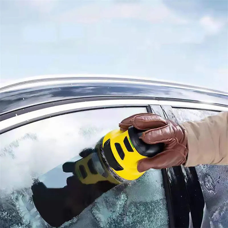Yellow cordless electric car ice scraper with USB charging cable on a car windshield.