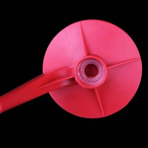 Red plastic Magic Tap soda dispenser mounted on inverted 2-litre bottle