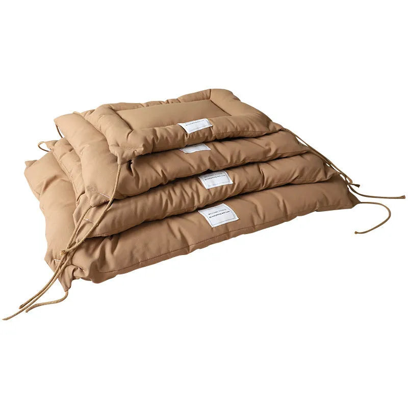 Tied cage cushion for dogs and cats in beige, showing platform attached to wire crate bars – size L.