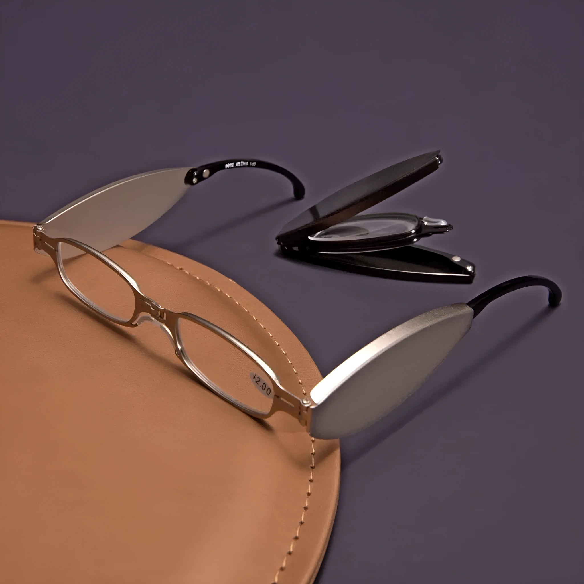 Folding presbyopic glasses in black frame showing collapsed and open positions with retro ring detailing