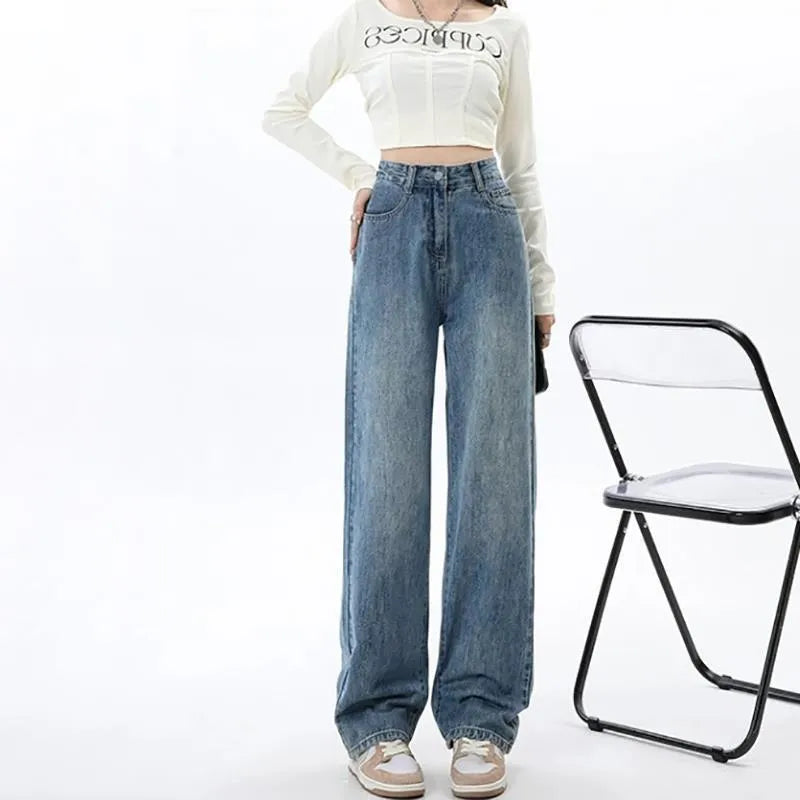 Women's retro blue wide leg jeans with high waist and straight leg design on denim background