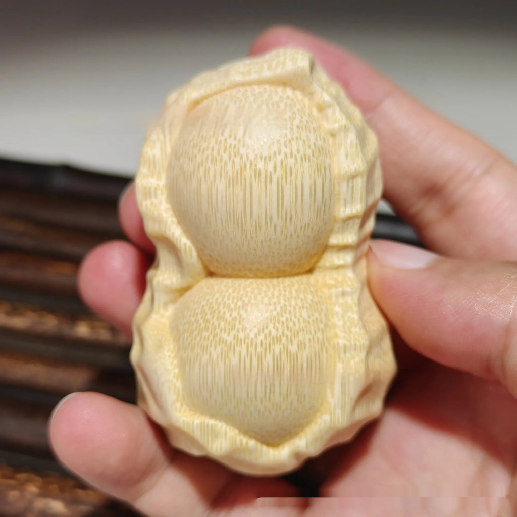 Solid bamboo carved peanut ornament with modern simplicity style and symbolic message.