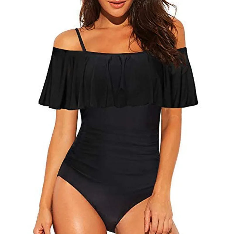 Black one-piece swimsuit with cut-out design and ruffled straps on a tube top.