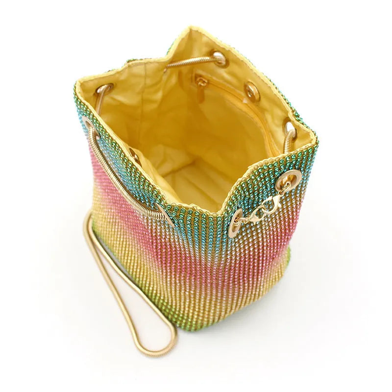 Rainbow coloured rhinestone bucket bag for women with adjustable fabric strap.