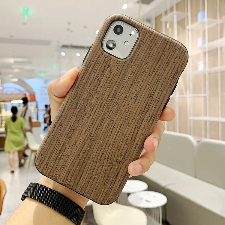 Wooden iPhone case with raised edge lip protection in natural bamboo or rosewood with visible grain patterns