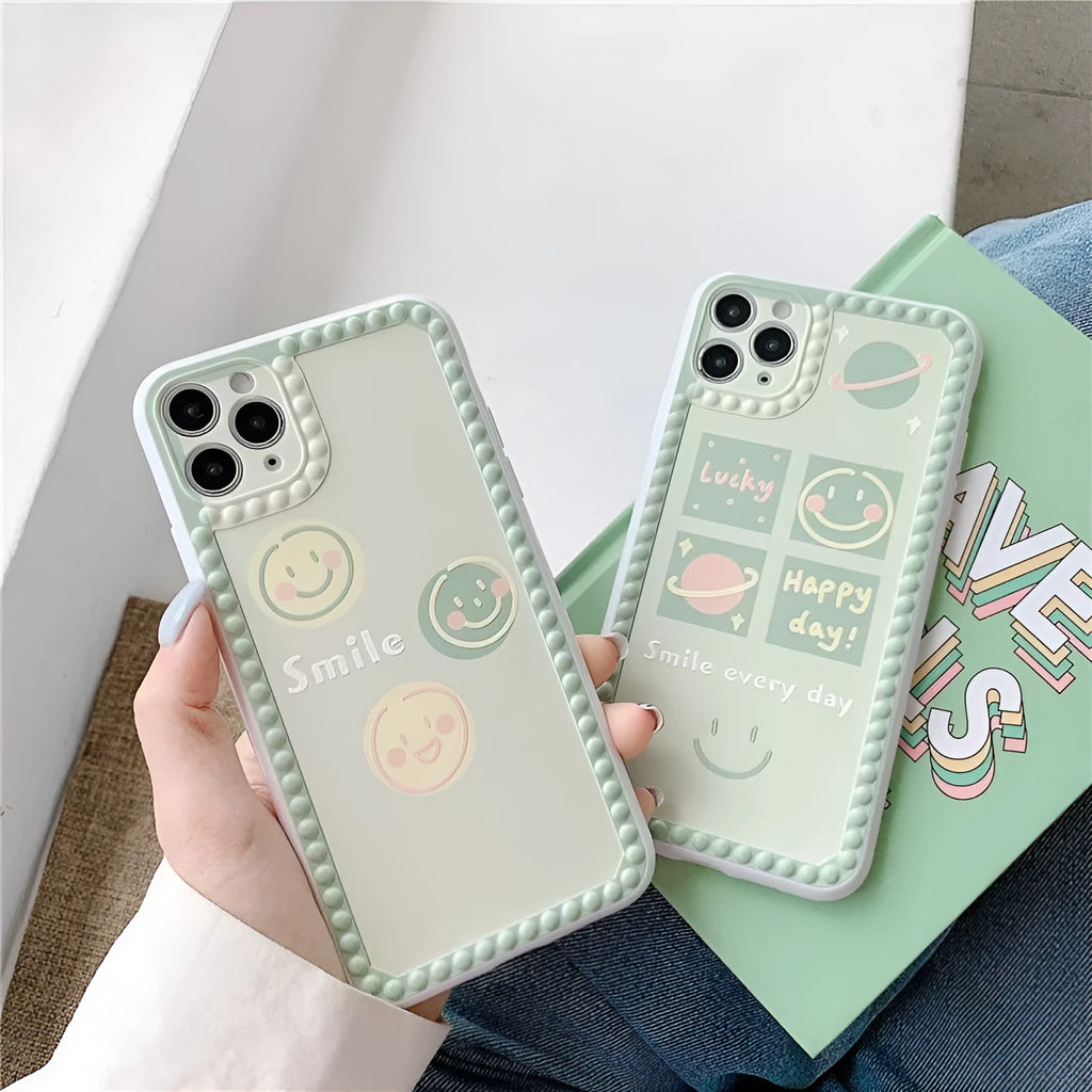 Green TPU iPhone back cover case with geometric smiley face and polka dot design.