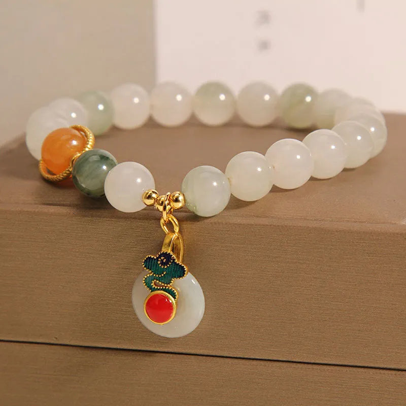 Ice jade colour women's bracelet with xiangyun buckle and pearl details.