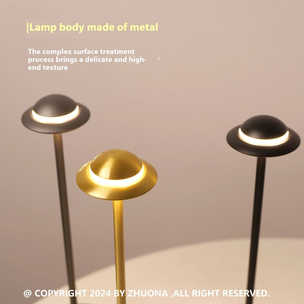 Modern UFO-shaped metal desk lamp with touch-sensitive base in black, gold, or grey finish.