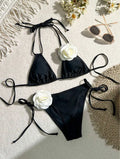 Black 3D flower lace drawstring bikini swimsuit with backless top and shorts on a model