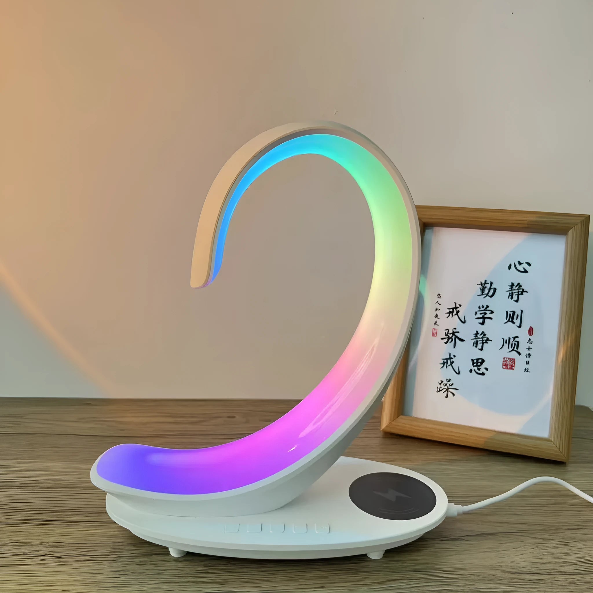White swan-shaped desk lamp with wireless charging pad and Bluetooth speaker, showing colourful LED lights.