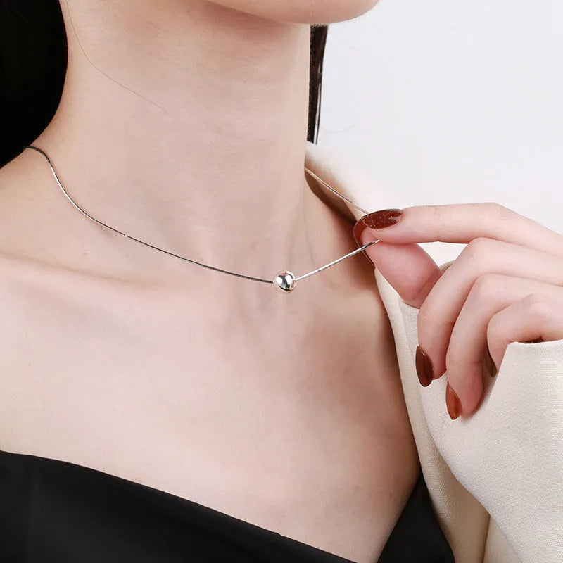925 sterling silver clavicle chain necklace with round ball pendant on woman's neck