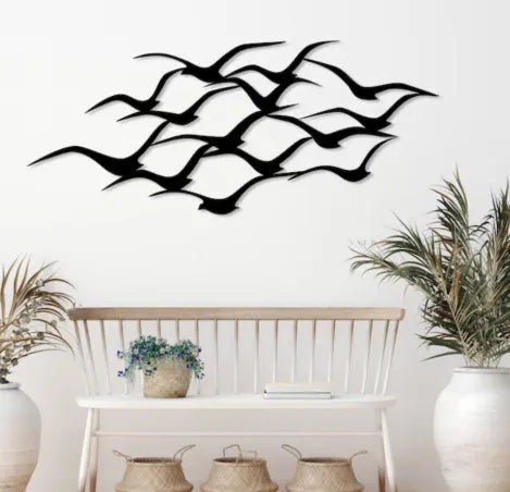Metal flying bird wall decoration with seagull finish on a white wall