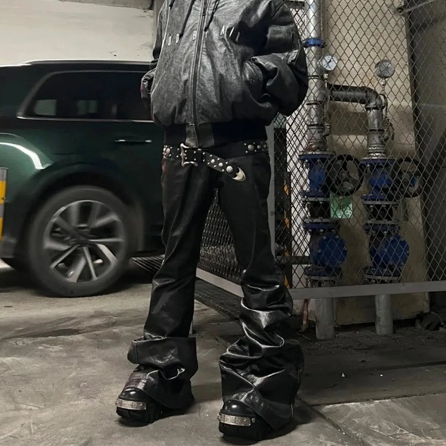 Black coated shiny patent leather straight-leg skinny jeans on a mid-waist