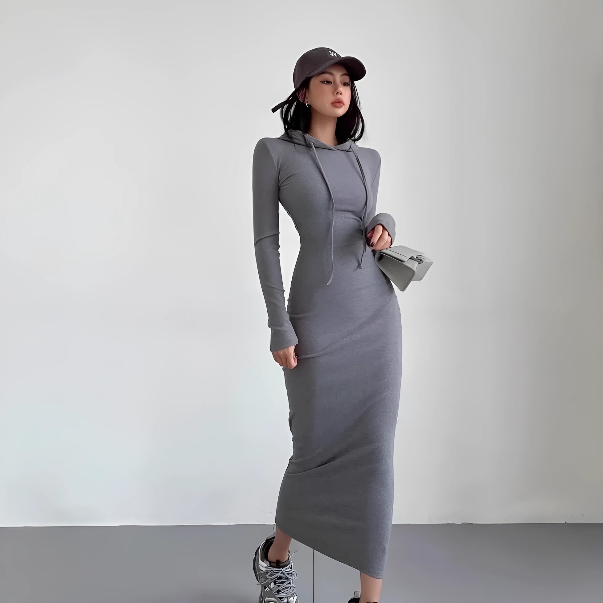 Women's grey hooded pullover dress with long sleeves and a high-waist sheath silhouette.