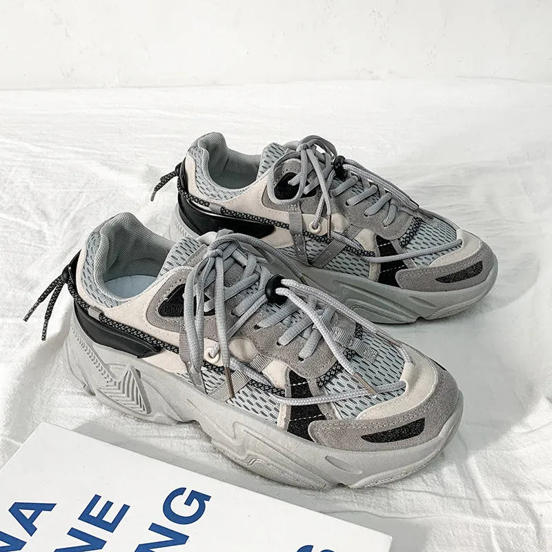 Men's white, black, and grey platform dad shoes with thick soles and lace-up front.