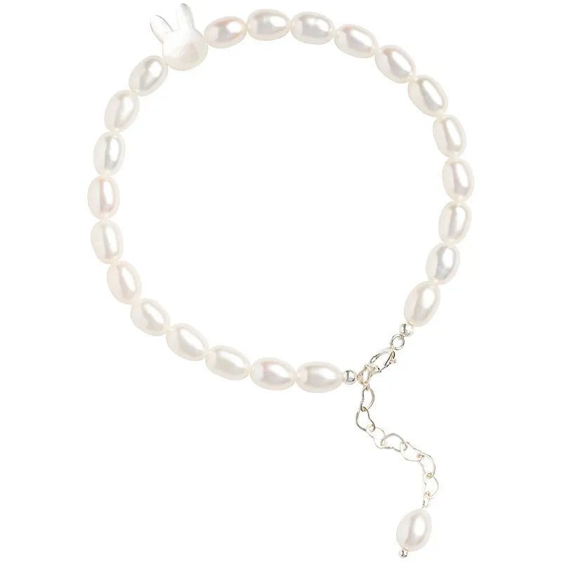 White shell small rice-shaped beads pearl elastic string rabbit bracelet 16cm handmade 925 silver on white background