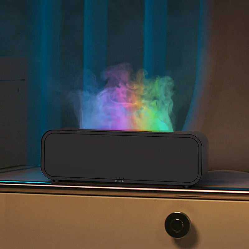 Black aroma diffuser with glowing orange flame effect and colour-changing LED base on a wooden table