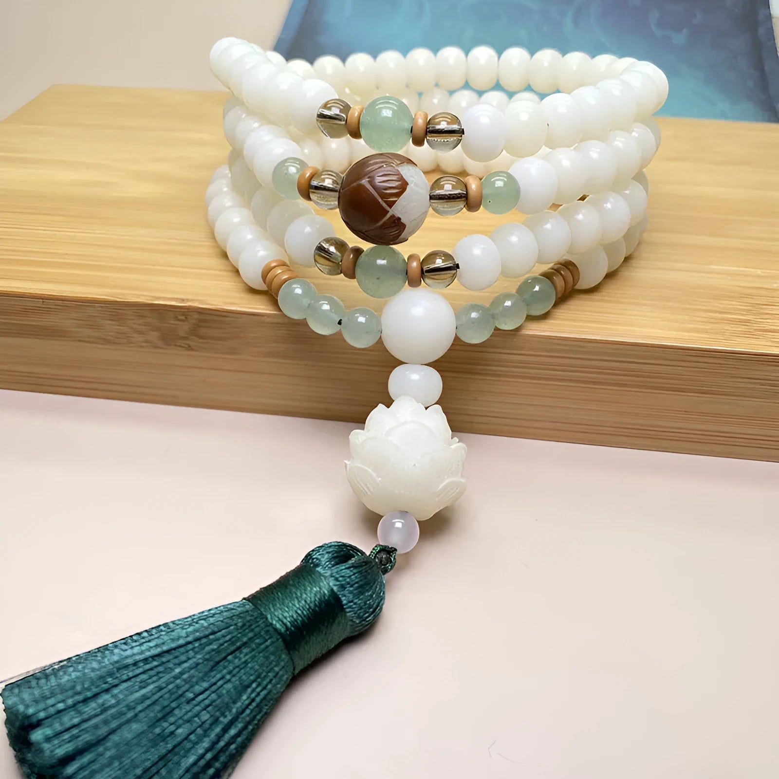 White Jade Bodhi 108 bead bracelet showing detail of spherical beads on a wrist.